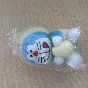 Doraemon holding a pear - car window accessory